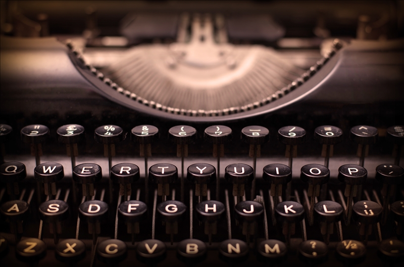 Close up of a dirty vintage typewriter, warm filter